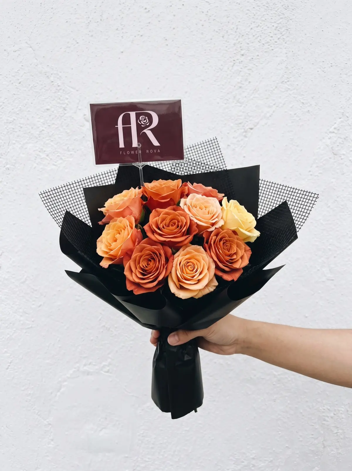 10 Orange Roses hand-tied in FlowerRova's black atelier wrap, Bangkok