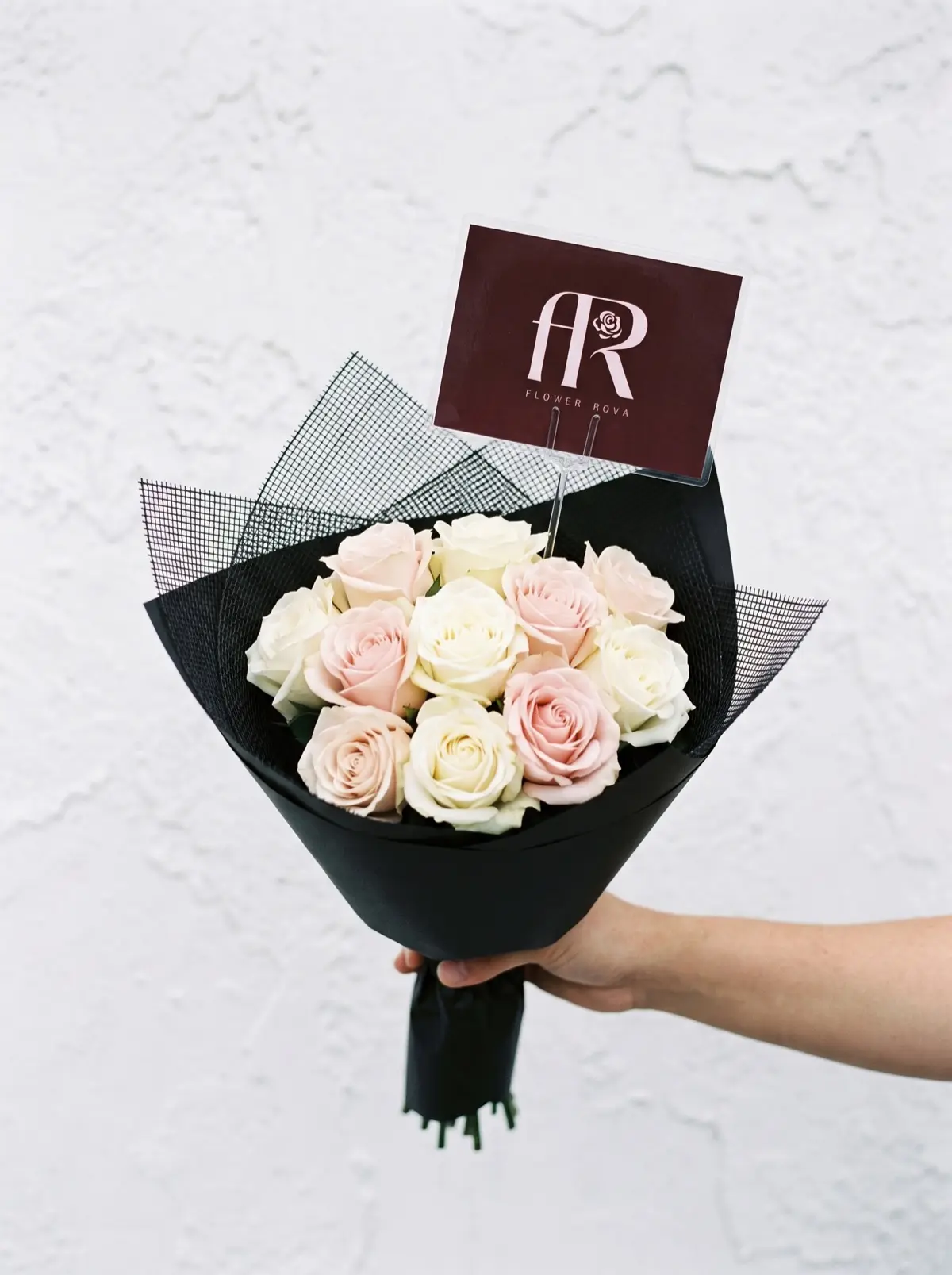 10 White + Pink Roses hand-tied in FlowerRova's black atelier wrap, Bangkok