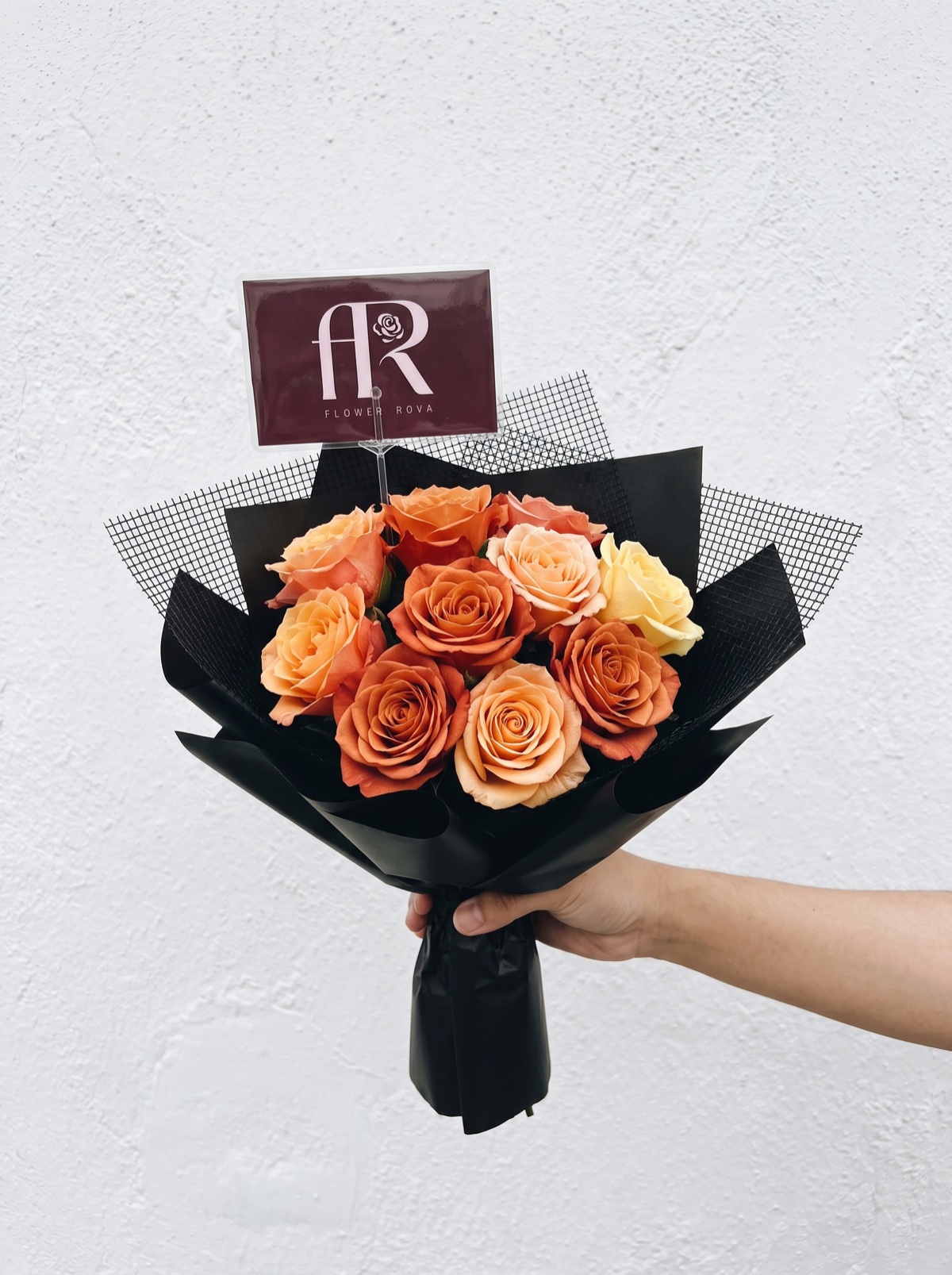 10 Orange Roses hand-tied in FlowerRova's black atelier wrap, Bangkok