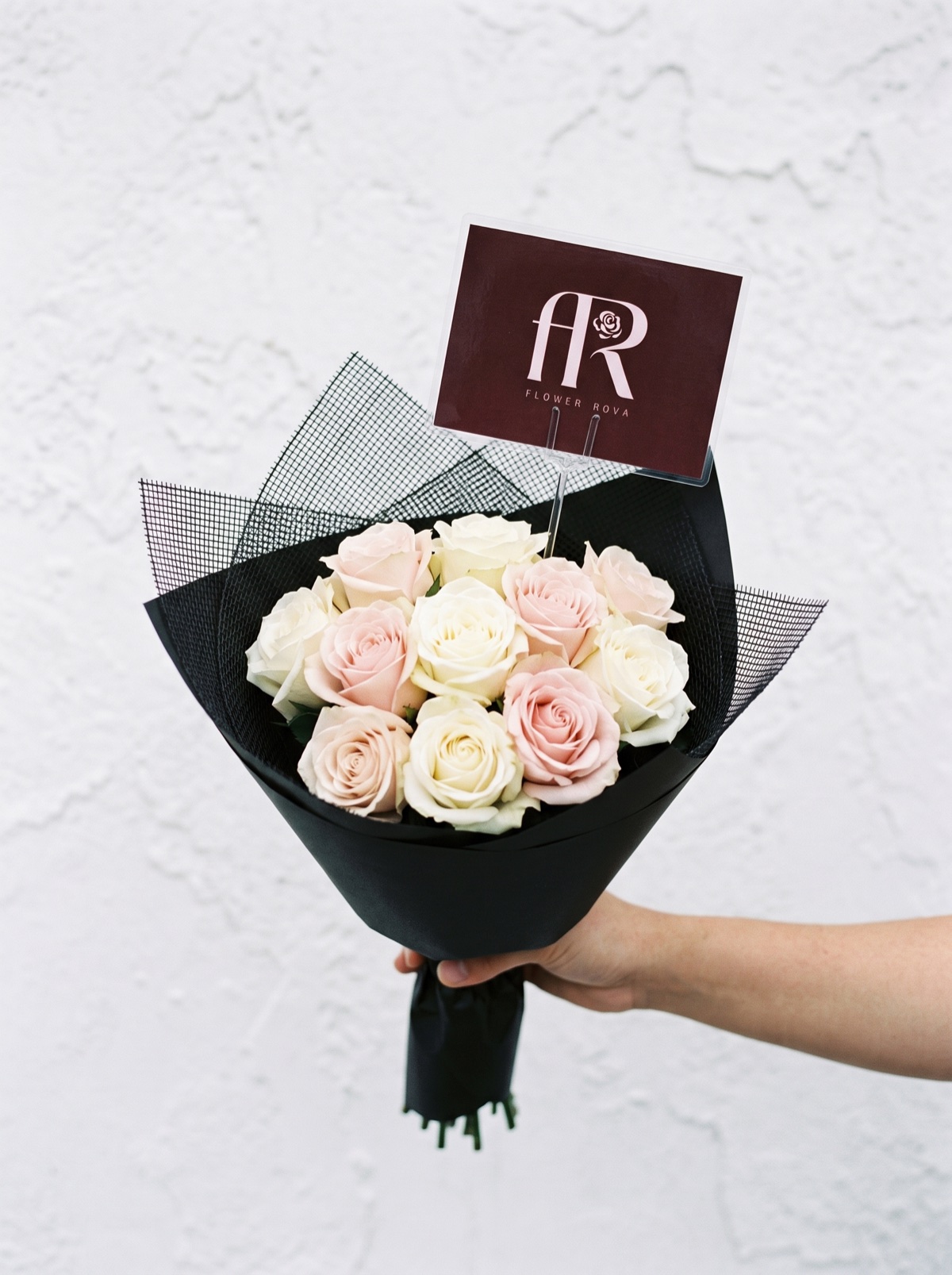 10 White + Pink Roses hand-tied in FlowerRova's black atelier wrap, Bangkok