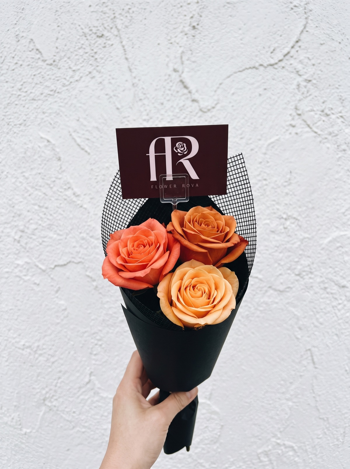 3 Orange Roses hand-tied in FlowerRova's black atelier wrap, Bangkok